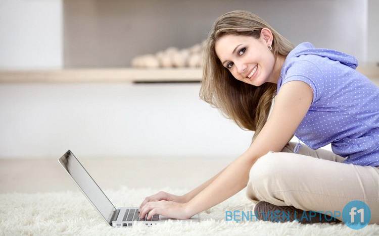Beautiful young woman working on a laptop indoors